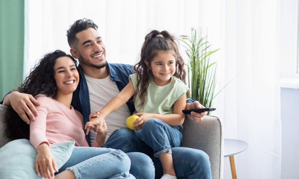 Family,Weekend.,Cheerful,Arabic,Parents,And,Their,Little,Daughter,Watching